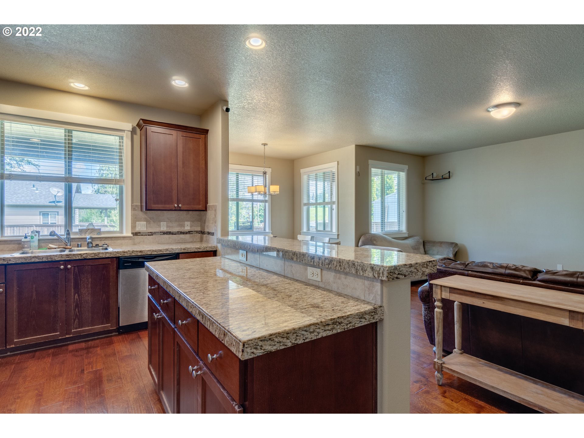 4310 North 4th Circle Ridgefield, WA 98642 - Photo 11 of 27 a kitchen with granite countertop a sink and stove