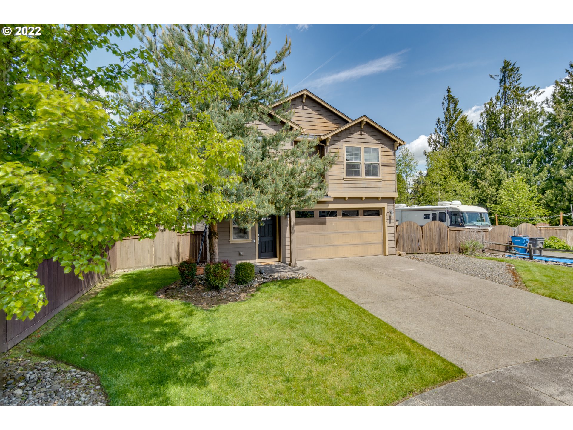 4310 North 4th Circle Ridgefield, WA 98642 - Photo 2 of 27 a front view of a house with a garden and trees