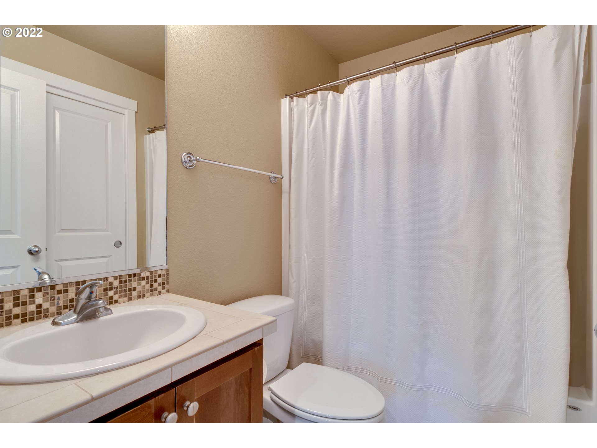 4310 North 4th Circle Ridgefield, WA 98642 - Photo 23 of 27 a bathroom with a sink and a mirror