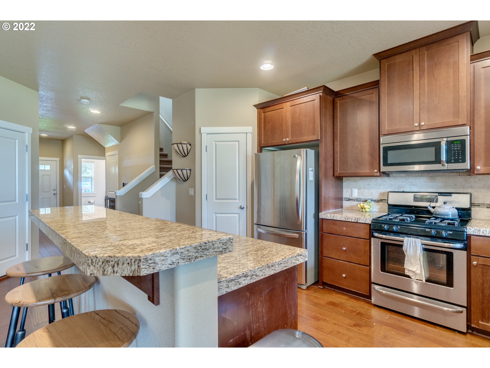 4310 North 4th Circle Ridgefield, WA 98642 - Photo 7 of 27 a kitchen with stainless steel appliances granite countertop a sink stove and refrigerator