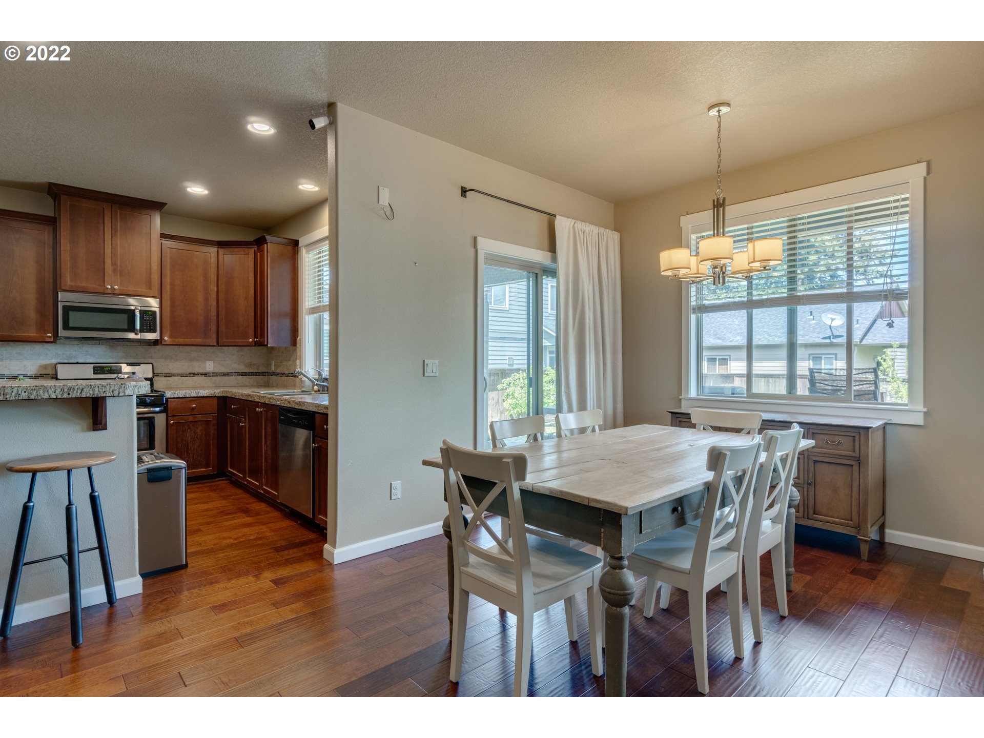 4310 North 4th Circle Ridgefield, WA 98642 - Photo 8 of 27 a view of a dining room with furniture window and wooden floor