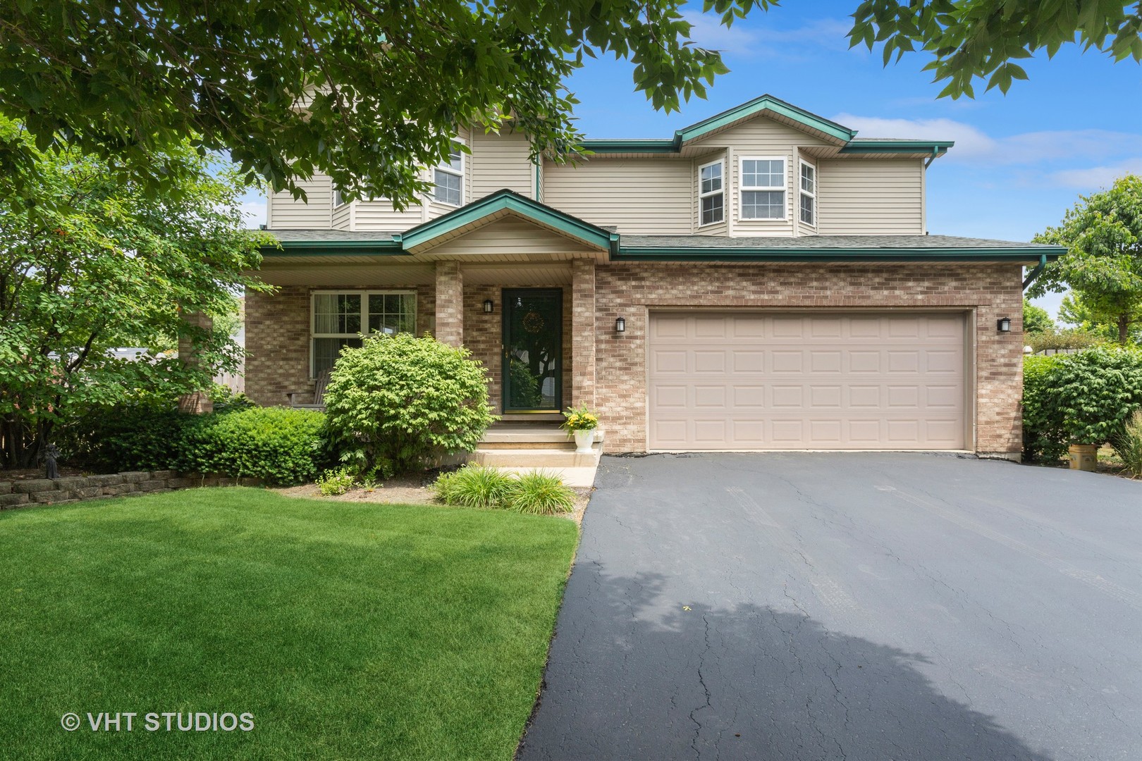 a front view of a house with a yard and garage