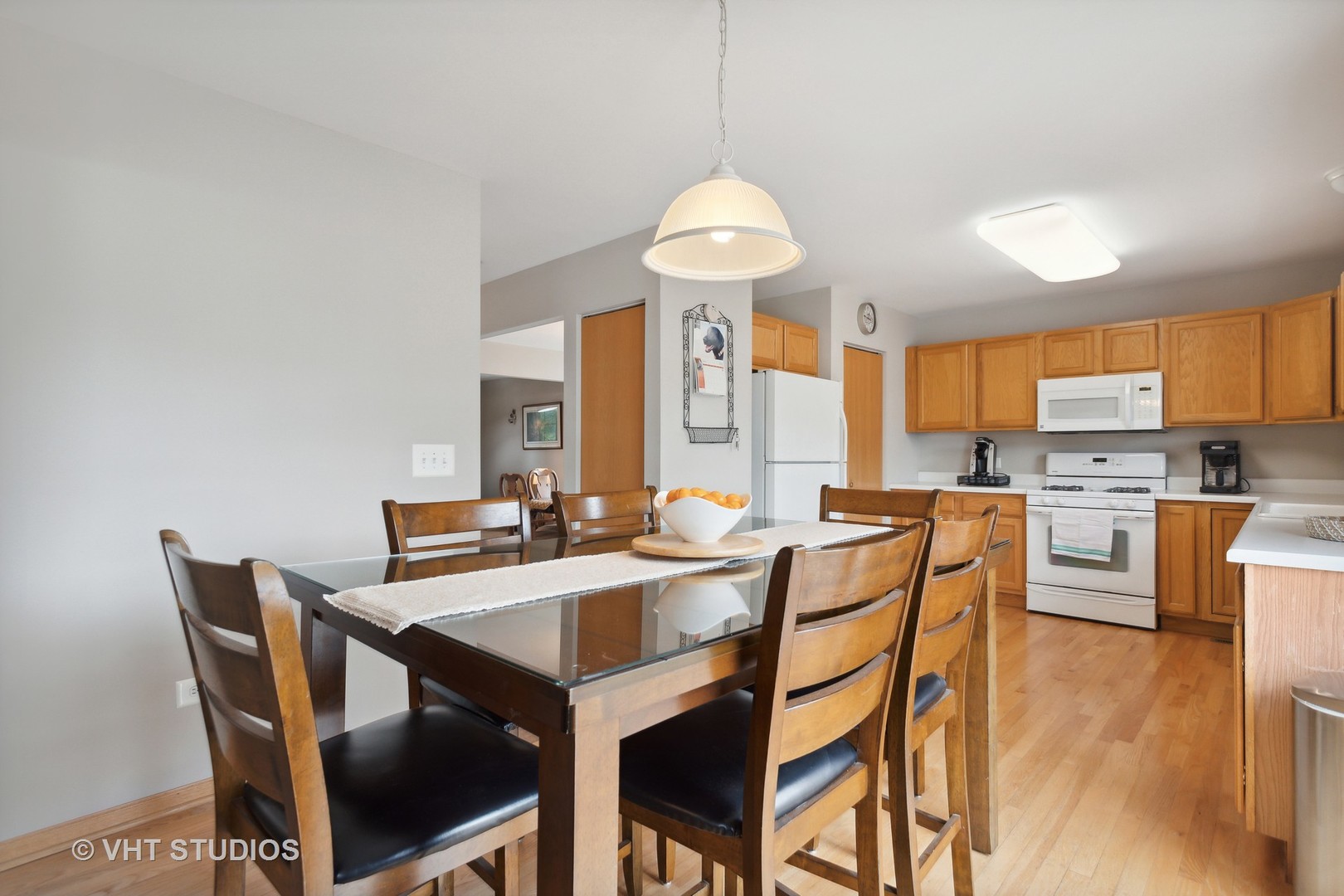 946 Premrose Court Romeoville, IL 60446 - Photo 7 of 25 a view of a dining room with furniture and wooden floor