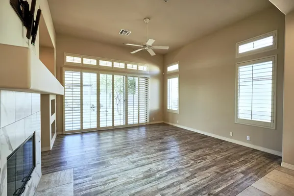 a view of an empty room with a fireplace and a window