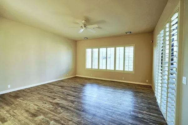 a bathroom with a granite countertop tub sink shower and mirror