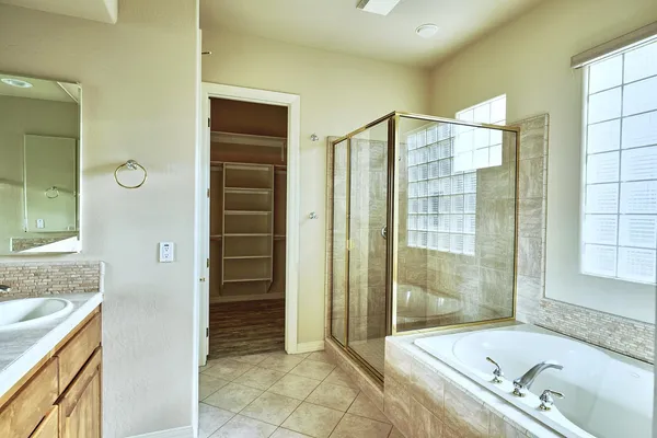 a bathroom with a shower sink and mirror