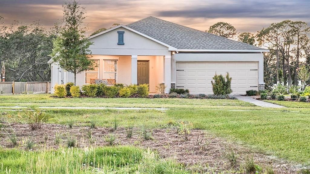 a front view of house with yard and green space