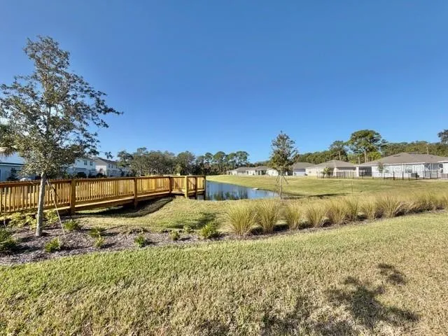 a view of a yard with wooden fence