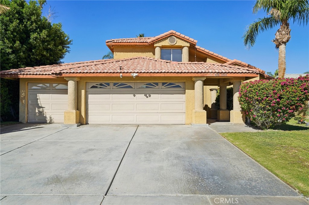 68290 Hermosillo Road Cathedral City, CA 92234 - Photo 1 of 1 a front view of a house with a yard and garage