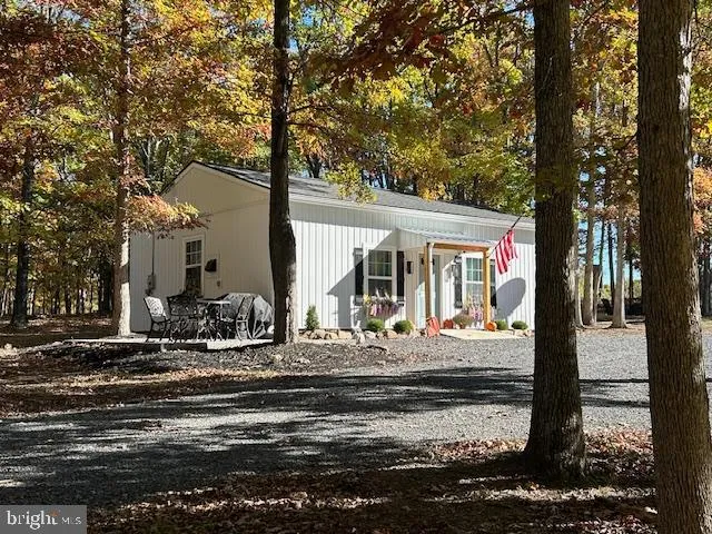 a front view of a house with sitting area