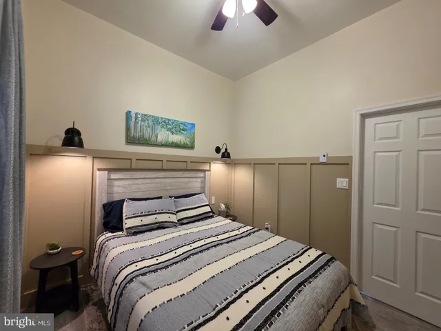 a bedroom with a bed and a chandelier