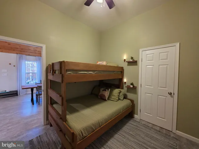 a small white house with a table and chairs