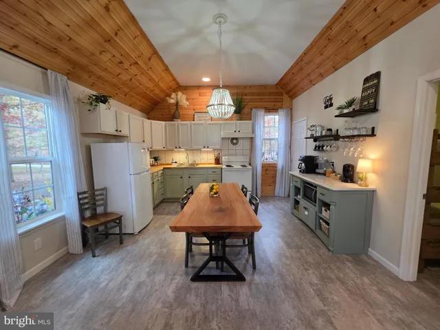 a large kitchen with a table and chairs