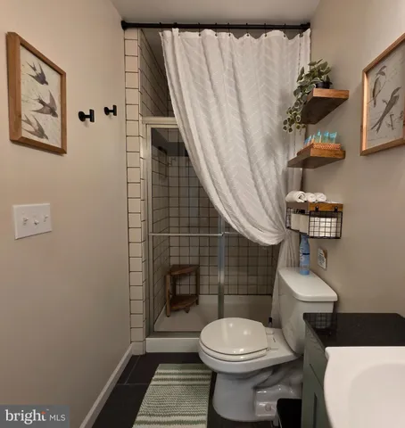 a bathroom with a toilet mirror and vanity