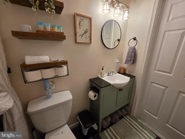 a white bed sitting in a bedroom next to a window