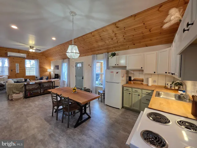 a very nice looking dining room with a large window table and chairs