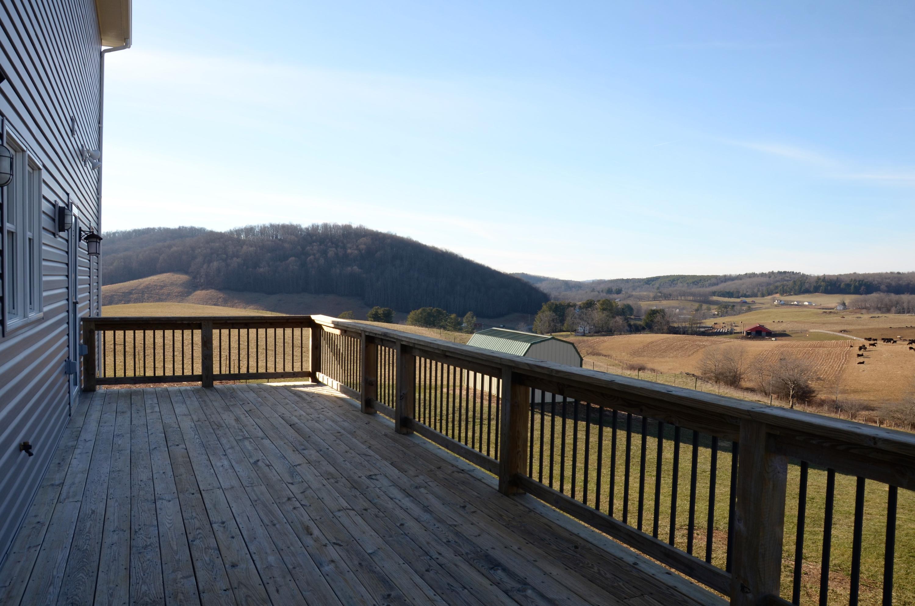 657 Poor Farm Road Southeast Floyd, VA 24091 - Photo 11 of 40 a view of balcony with wooden floor and fence