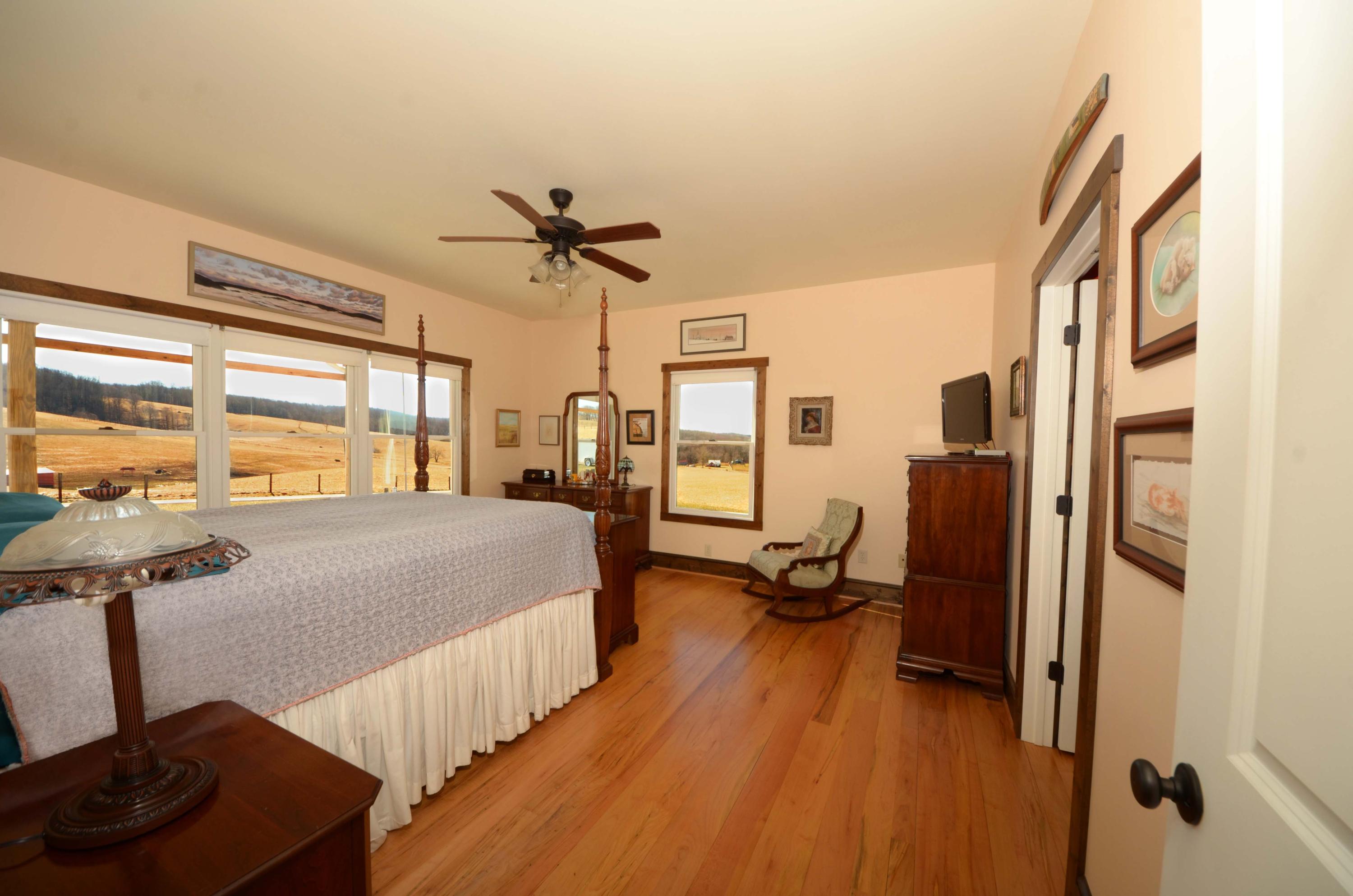 657 Poor Farm Road Southeast Floyd, VA 24091 - Photo 13 of 40 a bedroom with a bed and wooden floor