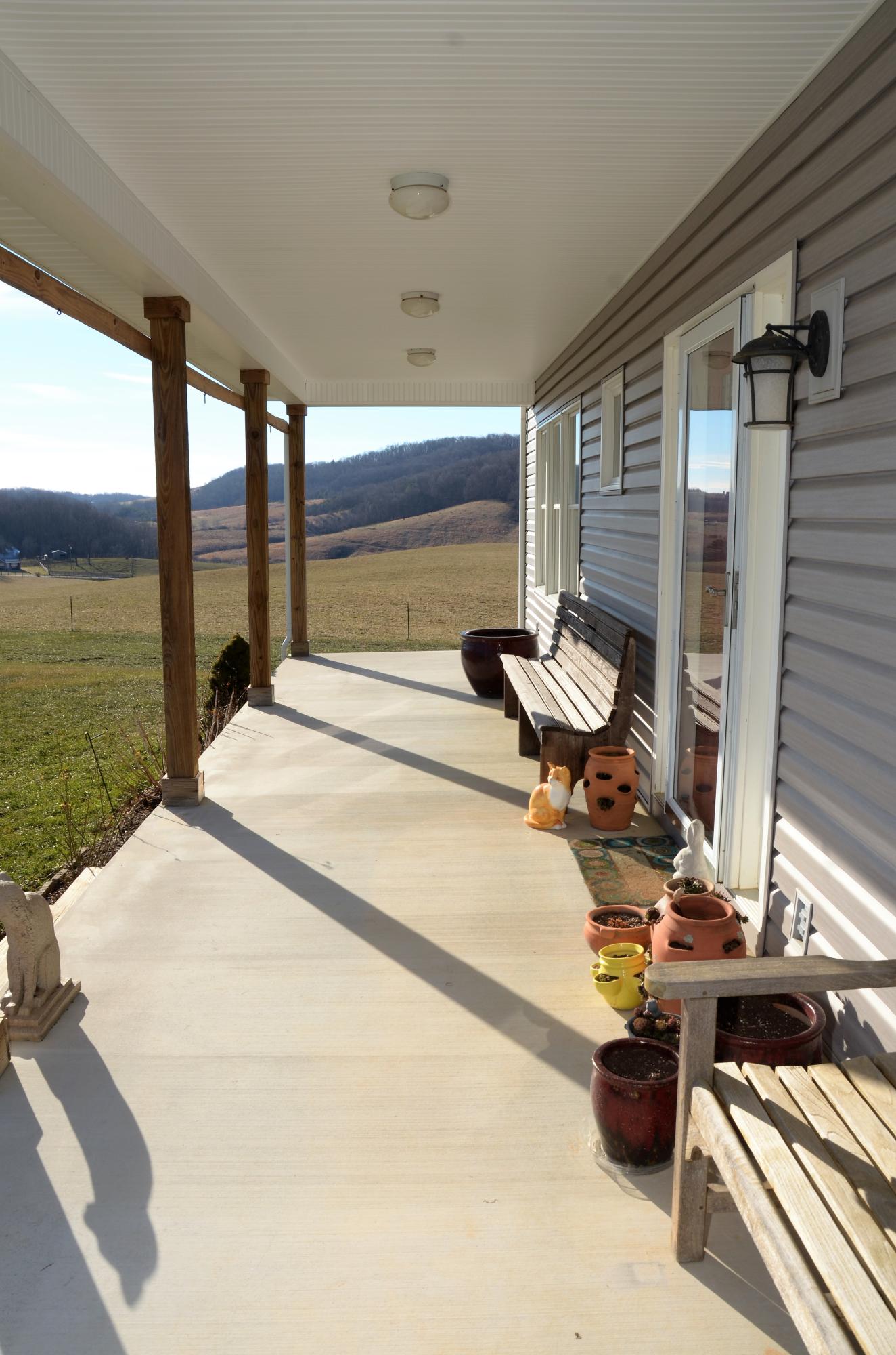 657 Poor Farm Road Southeast Floyd, VA 24091 - Photo 3 of 40 a building outdoor space with patio furniture and a potted plant