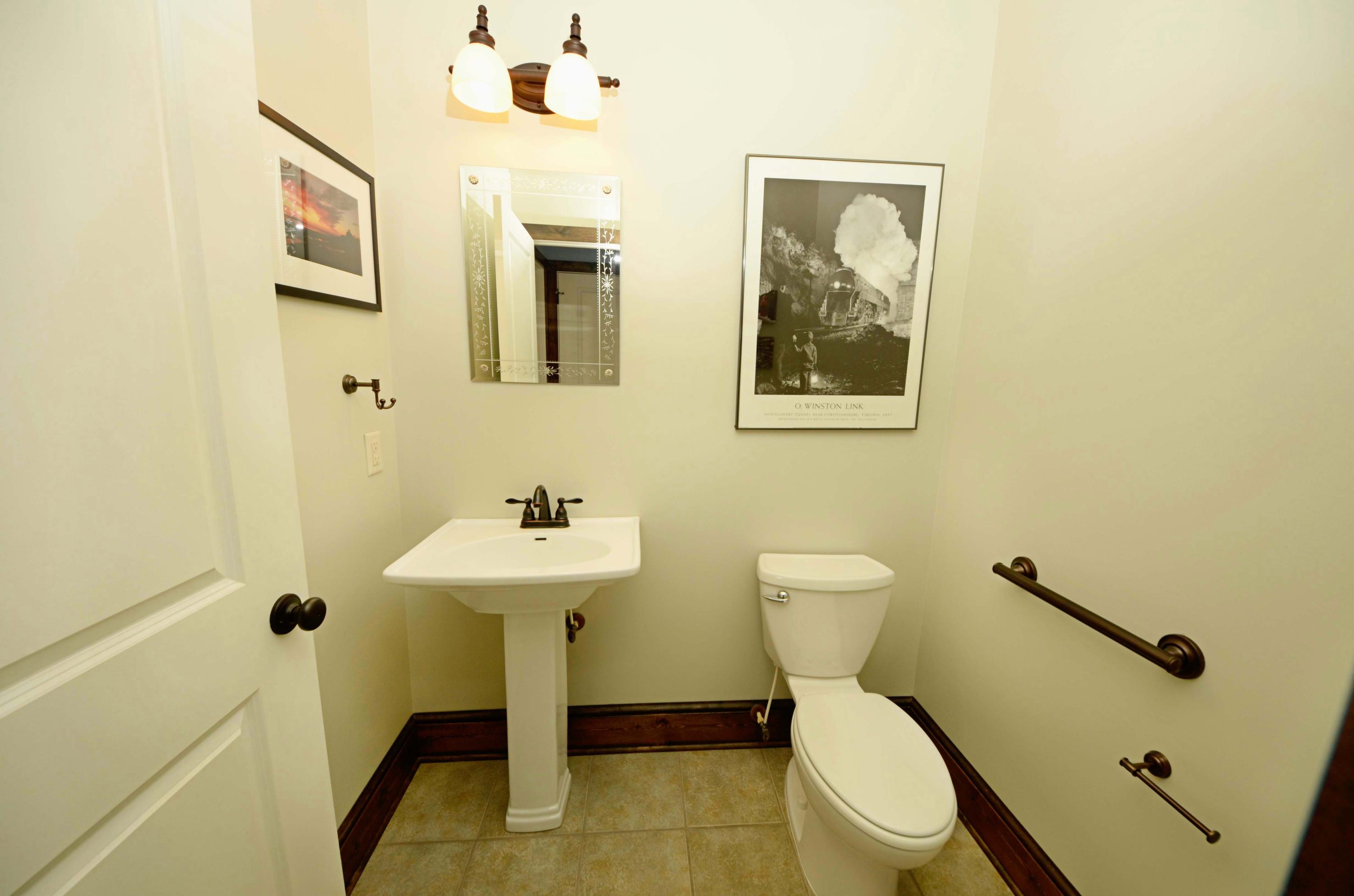 657 Poor Farm Road Southeast Floyd, VA 24091 - Photo 22 of 40 a bathroom with a toilet a sink and mirror