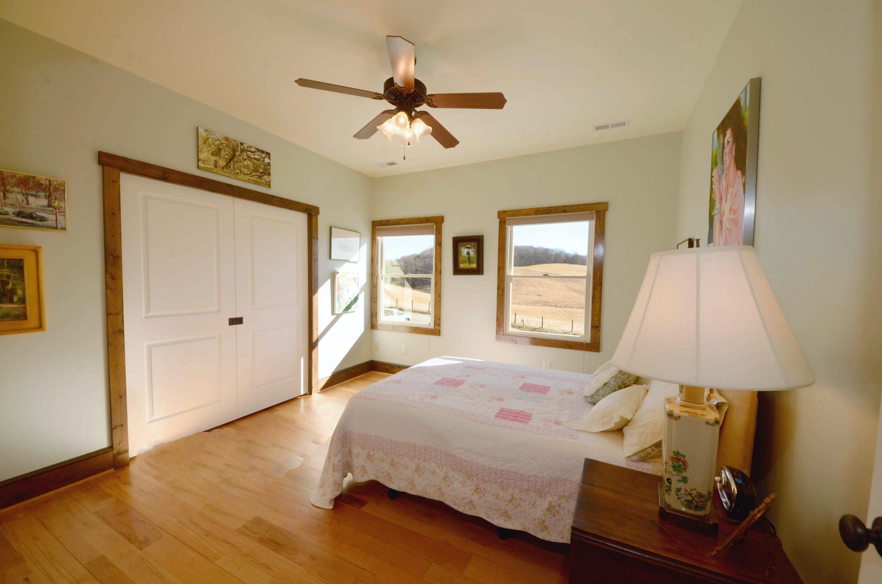 657 Poor Farm Road Southeast Floyd, VA 24091 - Photo 29 of 40 a bedroom with a bed and a lamp on table