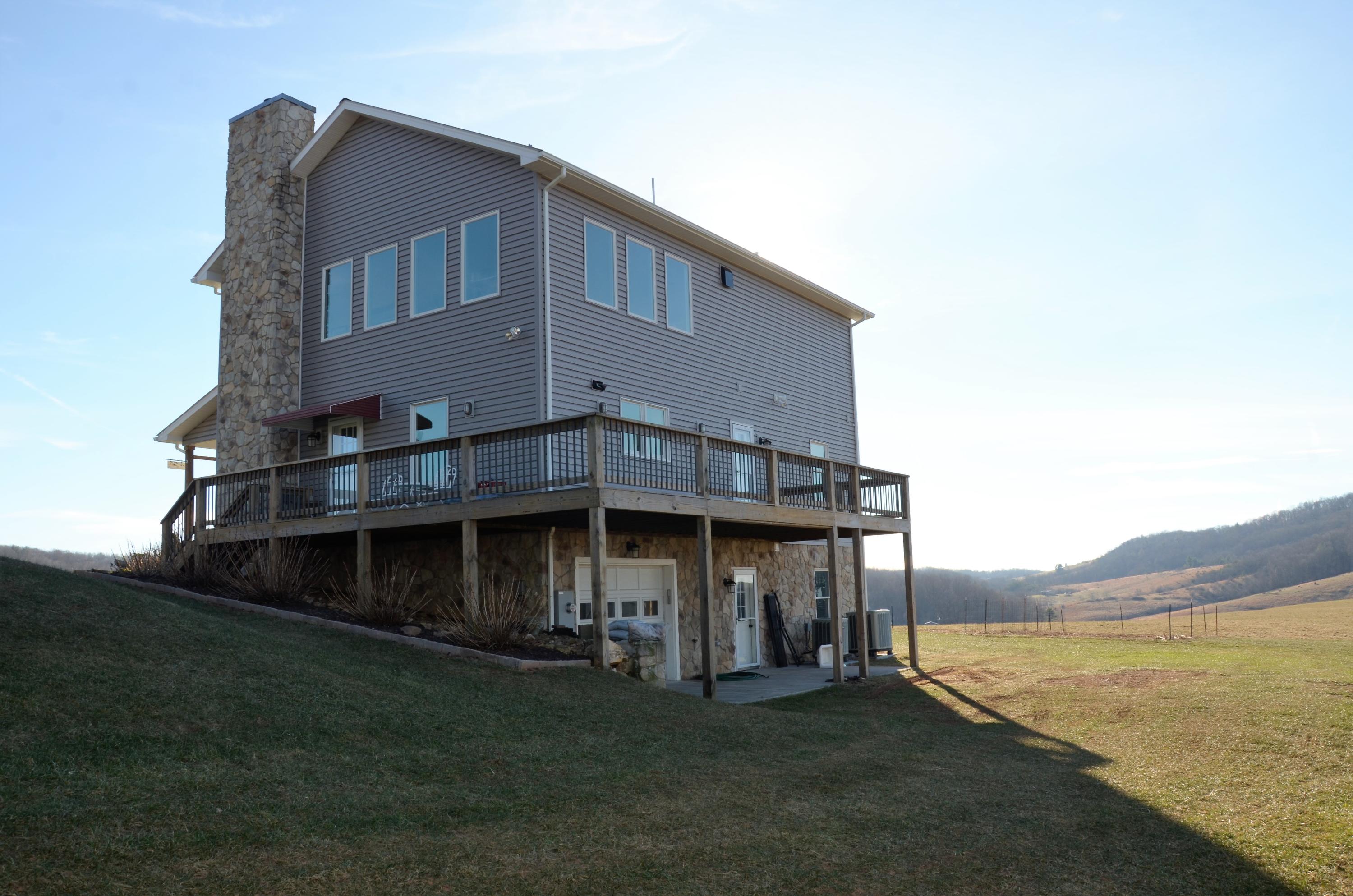 657 Poor Farm Road Southeast Floyd, VA 24091 - Photo 7 of 40 a view of a house with a yard and sitting area