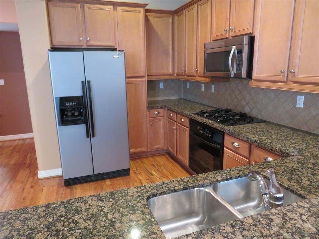 5908 Center Street Houston, TX 77007 - Photo 4 of 17 a kitchen with granite countertop a sink stove and refrigerator