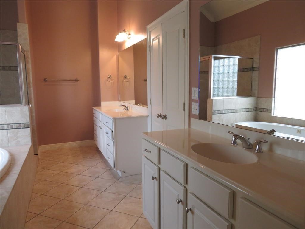 5908 Center Street Houston, TX 77007 - Photo 10 of 17 a spacious bathroom with a double vanity sink a mirror and a bathtub