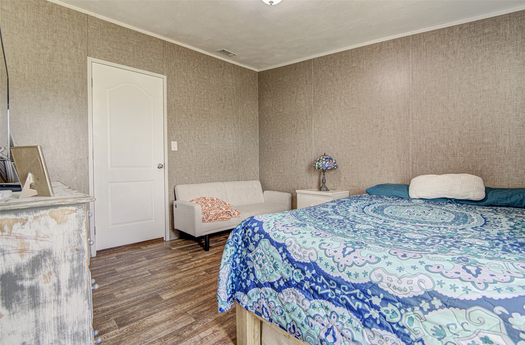 445 Rancho Linda Drive Lockhart, TX 78644 - Photo 20 of 26 Natural light illuminates the rich wood flooring in this comfortable bedroom space.