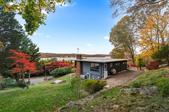 a view of a house with a yard patio and a garden