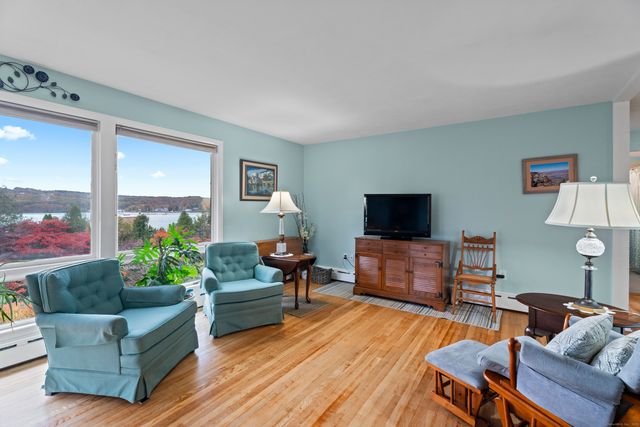 a kitchen with a table chairs refrigerator and window
