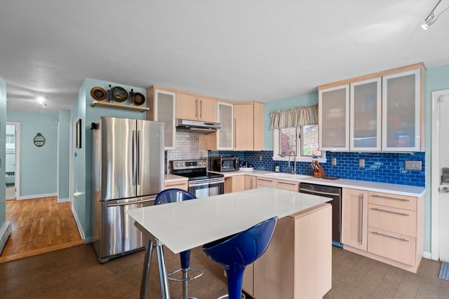 a kitchen with a sink a stove and refrigerator