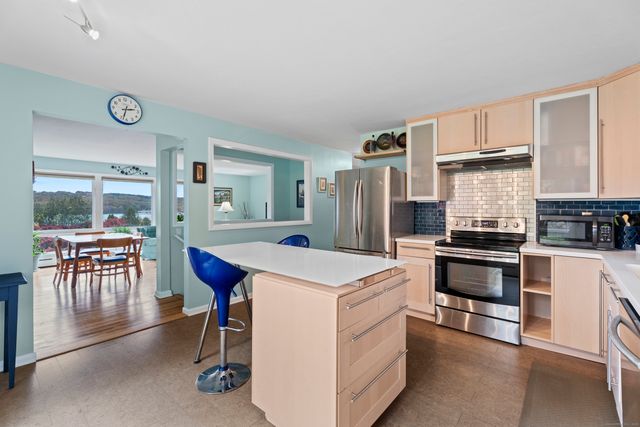 a bedroom with a bed wooden floor and window