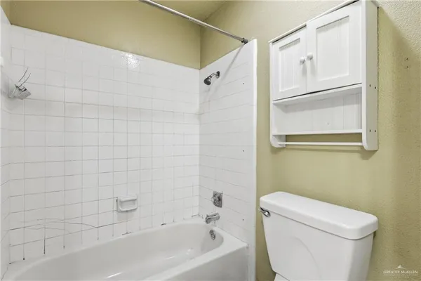 a bathroom with a toilet and a bathtub