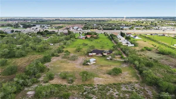 an aerial view of residential houses with outdoor space and lake view