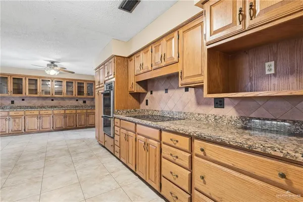 a kitchen with stainless steel appliances granite countertop a sink and cabinets