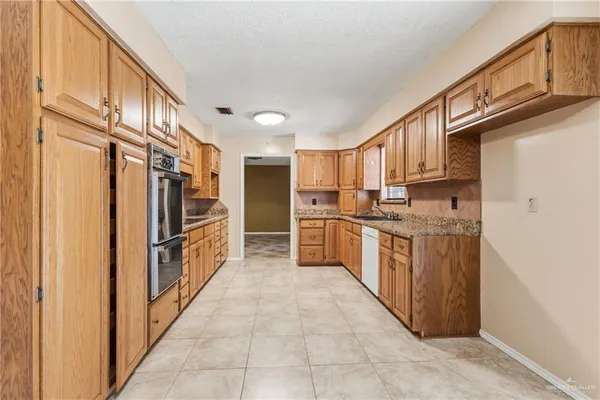 a kitchen with cabinets and stainless steel appliances