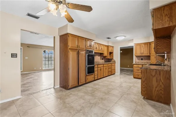 a view of a kitchen with furniture a kitchen a sink and refrigerator