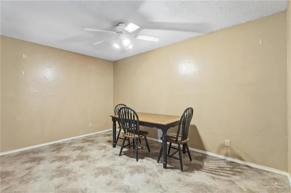 a view of a room with a table and chairs