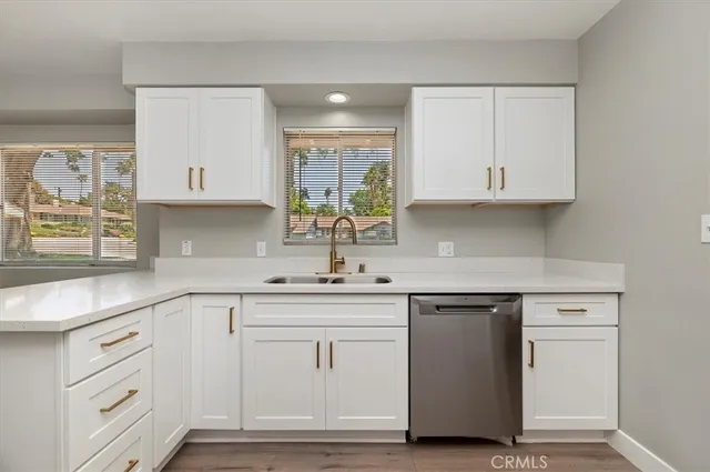 a kitchen with white cabinets and a sink