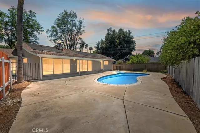 a view of a house with backyard and tree