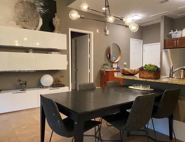 a kitchen with stainless steel appliances granite countertop a sink and a refrigerator
