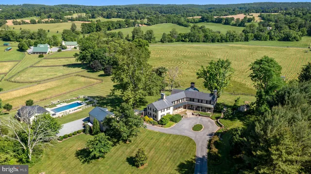 an aerial view of residential houses with outdoor space and river