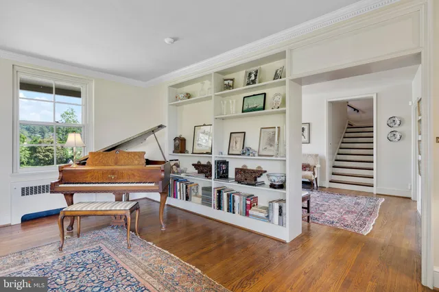 a bedroom with furniture and large windows