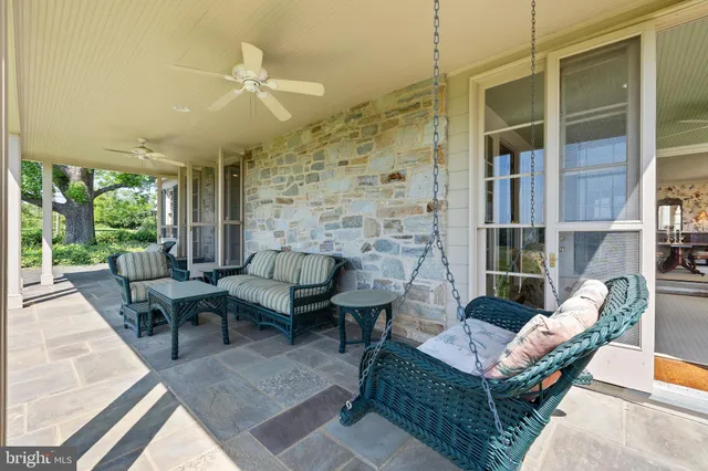 a view of a patio with table and chairs with wooden floor and fence