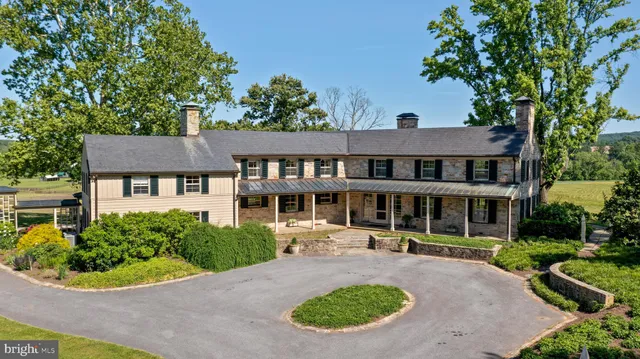 an aerial view of a house with yard swimming pool and outdoor seating