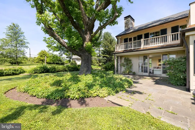 a front view of a house with a yard table and chairs