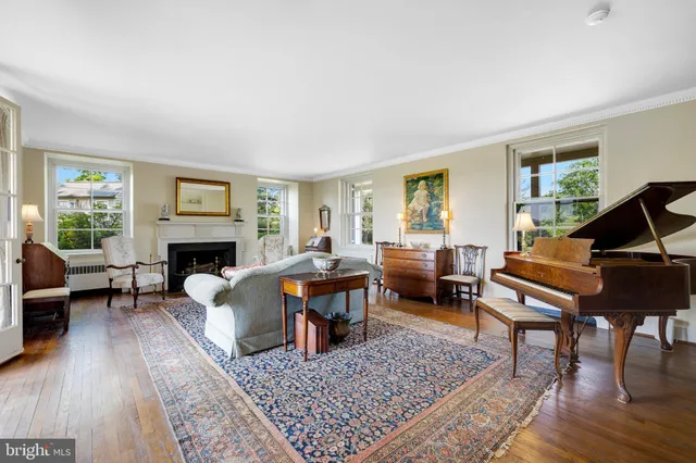 a living room with furniture a large window and a fireplace