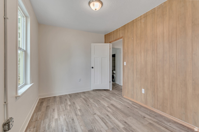 8831 South 400 East Sandy, UT 84070 - Photo 19 of 26 Spare room featuring light wood finished floors and wood walls