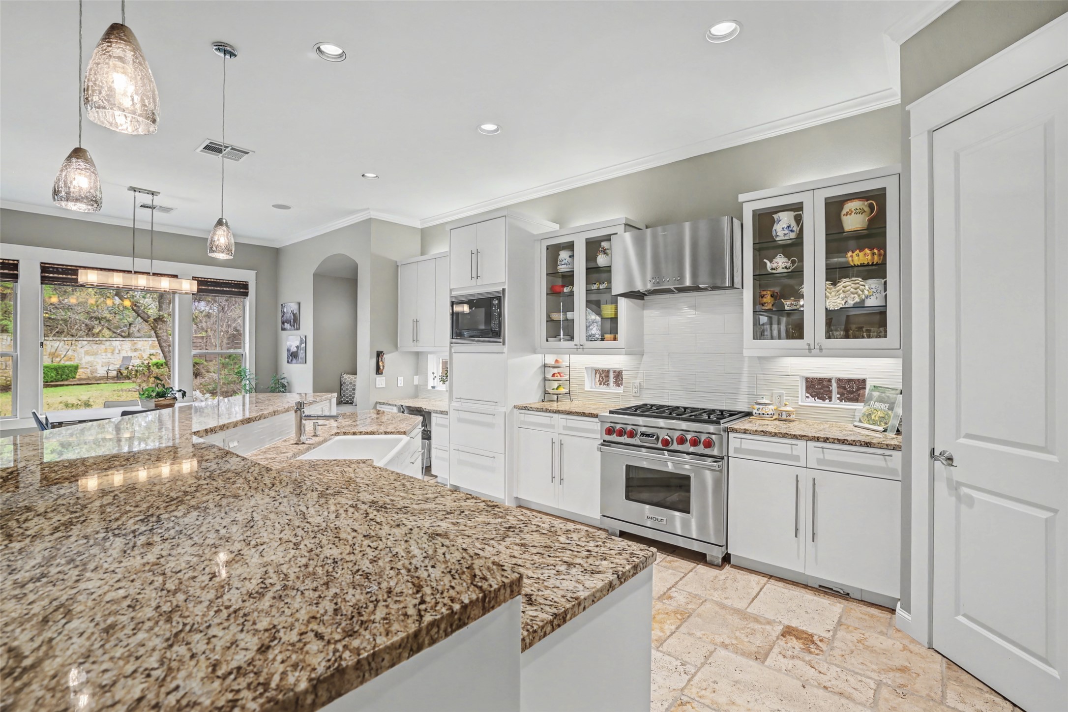 816 Stonewall Ridge Lane Austin, TX 78746 - Photo 11 of 32 Culinary delights await in this bright kitchen boasting Wolf and Thermador stainless appliances, new dishwasher, updated cabinets and backsplash -- perfect for entertaining. Walk in pantry and appliance cubby under the microwave. Lots of storage!